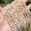 Macro view of faceted peach and white opaque glass beads for handmade DIY jewelry making - 4x3mm (112 Pieces/Pack) / Crystal White Jade Half Amber