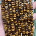 Close-up detail showing texture of 4x8mm faceted natural tiger eye stone abacus spacer beads - 75 Pieces/Pack / Tiger's Eye