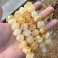 Macro detail of faceted natural yellow crystal barrel beads for DIY handmade jewelry crafting. - Approx. 15x20mm / Citrine