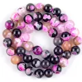 Macro view of magenta and black swirling pattern chalcedony natural stone round beads - 6mm (Approx 58 Pieces) / Two-Tone Rose Red Round Fire Agate