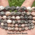 Detailed view of faceted natural stone beads featuring unique gray and peach mottled patterns. - 6mm Approx 58 Pieces / Faceted Pink Zebra