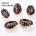 Macro view of natural cowrie shell beads with black geometric patterns for DIY jewelry - 10 Pieces/Pack (16-20mm) / Ancient Ceramic Pattern