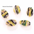 Detailed view of colorful printed natural cowrie shell beads for DIY jewelry making - 10 Pieces/Pack (16-20mm) / Yellow Green and Black Stripe Pattern