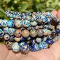 Detailed macro shot of various 4-10mm natural colorful Emperor Stone jasper round beads - 88-90 Pieces/Pack / 4mm / Lapis Flower Imperial Jasper