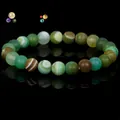 Natural green striped agate beaded bracelet presented on a reflective black background - 19cm 6mm / Green Striped Agate