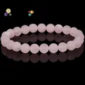 Natural rose quartz beaded bracelet with a smooth matte finish on black background - Rose Quartz