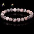 Natural pink and gray patterned stone bead elastic bracelet on black background - Pink Zebra Stone