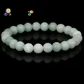 Natural light green stone beaded bracelet for women on a black background - Burma Jade