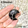 Detailed view of handmade black obsidian moon pendant with silver wire-wrapped tree of life. - Obsidian