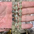 Macro detail of faceted natural prehnite cube beads with black rutilated inclusions - 10mm / Prehnite