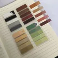 Macro view of Morandi color PET index stickers on a lined notebook page - Combination