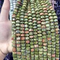 Close-up of 6x10mm faceted green and pink Unakite stone beads for jewelry DIY. - Unakite / 1 Piece/Pack