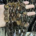 Close-up of high-quality natural transparent smoky quartz oval beads for DIY jewelry - Irregular Tumbled Style / Approx 15X25mm / Tea Brown
