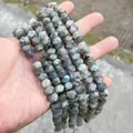 Macro view of faceted grey labradorite beads with natural blue sheen for DIY jewelry - 58 Pieces / Flash Stone (Labradorite)