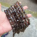 Detailed close-up view of dark brown faceted smoky quartz beads for handmade DIY jewelry crafting - 58 Pieces / Smoky Quartz