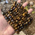 Detailed macro view of faceted natural tiger's eye stone beads for DIY jewelry making - Approx. 9x15mm / Tiger's Eye