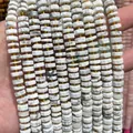 Macro detail view of faceted 4x8mm abacus white stone beads for handmade DIY jewelry components - 75 Pieces/Pack / Howlite