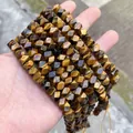 Close-up of faceted natural Tiger's Eye stone beads for handmade DIY jewelry making projects. - 58 Pieces / Tiger's Eye