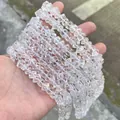 Macro view of clear faceted crystal beads held in hand for jewelry making - 58 Pieces / White Crystal