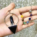Close-up detail of a 7 chakra natural stone hexagonal point pendant and beaded bracelet set - Natural / Obsidian