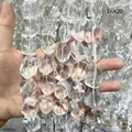 Close-up view of irregular tumbled natural clear quartz crystal beads sized 16x20mm - 15x20mm (Nearly Flawless) / Clear