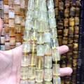 Hand holding faceted light yellow natural crystal cylinder beads for DIY jewelry making 12x16mm - 21 Beads Set / Lemon Quartz