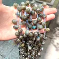 Macro view of faceted natural labradorite teardrop beads with blue flash for jewelry DIY - Glitter
