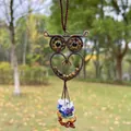 Detail shot of a handmade wire-wrapped owl pendant with colorful chakra gemstone beads. - Tiger Eye Stone Bracelet