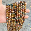 Detailed close-up of multi-colored natural stone round beads for DIY jewelry making - Ocean Jasper