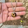 Polished natural tiger eye stone donut pendant necklace detail showing stone texture - Tiger Eye (Pendant Only)
