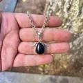 Close-up view of a blue goldstone angel wing pendant showing fine stone texture - Pendant Only (No Chain) / Obsidian