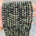 Close-up detail of dark green and black natural dragon blood stone round beads for DIY jewelry - Variscite