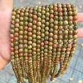 Close-up of natural Dragon Blood Jasper round stone beads for DIY jewelry making projects - Unakite