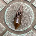 Vintage hexagonal crystal pendant with 12-facet cut and antique copper bat wing wire wrap - 12 Facet Hexagonal Cone (B18) / Antique Bronze Tiger Eye