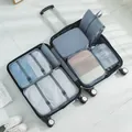 A comprehensive 7-piece grey travel packing cube set organized inside a silver suitcase - 7-Piece Set / Gray