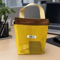 Portable yellow mesh handheld toiletry bag with brown accents and Storage bag label - Yellow