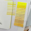 Detail showing ultra-thin yellow gradient PET transparent index stickers on a notebook - 16 Pieces Pack / Yellow Gradient