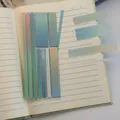 Detail shot of transparent gradient index stickers on notebook pages - Blue Gradient