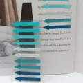 Close-up of Morandi colored arrow index tabs used on a book page for reading and marking. - Cyan