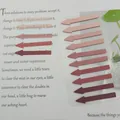 Detailed view of Morandi colored arrow index tabs applied on a book page for reading - Gradient Pink