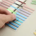 Morandi colored arrow index tabs shown being peeled from transparent sheet - Pale Blue