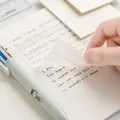 Close-up of a transparent PET sticky note being peeled over handwritten notebook text - 50 Sheets/Pack (50x50mm)