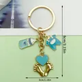 Cute blue baby themed alloy keychain featuring bottle and outfit charms, 8cm in total height - Blue Clothes Milk Bottle Heart Footprints Style (ER1520)