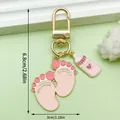 Cute pink baby footprint and milk bottle charm keychain with gold-toned clasp. - Pink Milk Bottle Footprints U-Shape Clasp Style (ER1515)