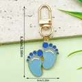 Cute blue baby footprint enamel keychain with gold lobster clasp, dimensions shown 6.8x3cm - Blue Feet U-clip Style (ER1513)