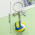 Sporty volleyball keychain featuring colorful rubber ball and silver heart charm - Volleyball (ER1532)