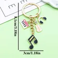 Vintage alloy musical instrument keychain with music note, piano, and violin charms - Piano Headphone Violin Style (ER2197) / Pink