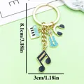Music themed keychain with piano guitar headphones and note charms 8.1cm length - Piano Headphone Violin Style (ER2198) / Lake Blue