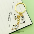 Western cowboy style enamel keychain featuring horse boot and hat charms gold tone - White Enamel Hat Boot & Pony (ER1266)