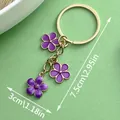 Purple enamel flower pendant keychain with golden ring for bags, dimensions 7.5cm by 3cm - Purple Flower (ER568) / Purple